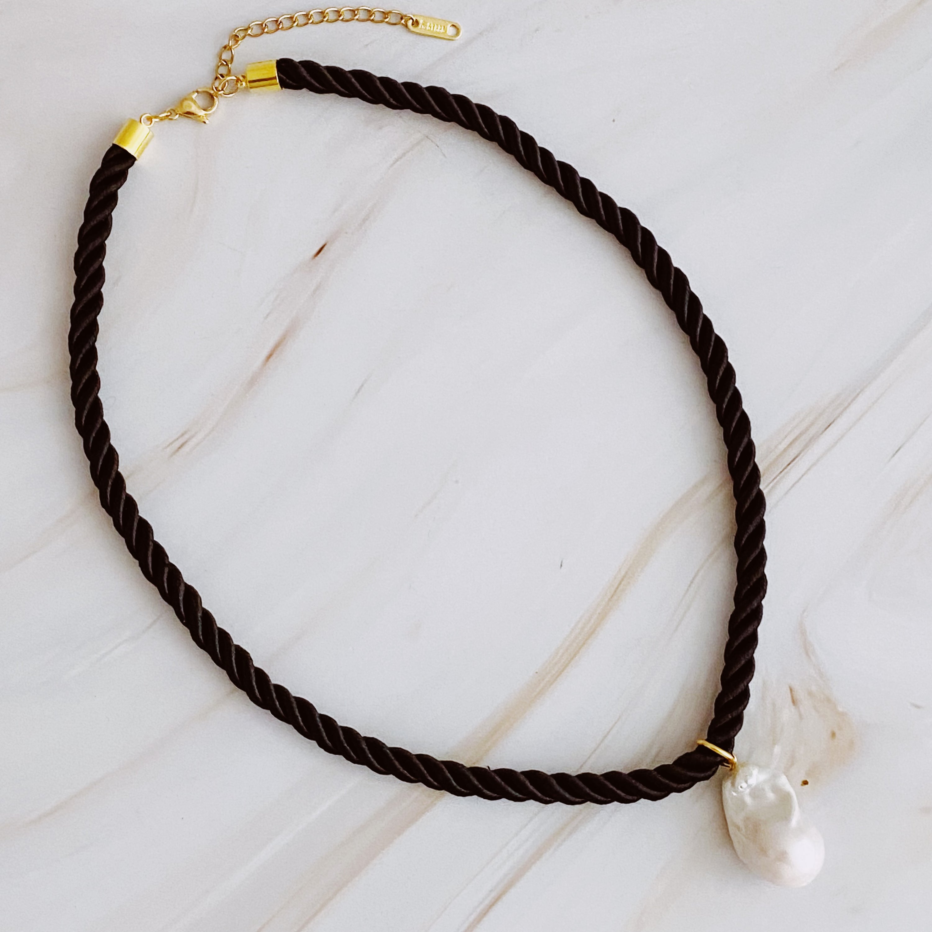 A stylish Satin Rope Baroque Pearl Necklace featuring a unique baroque pearl and elegant satin rope design, perfect for any occasion.