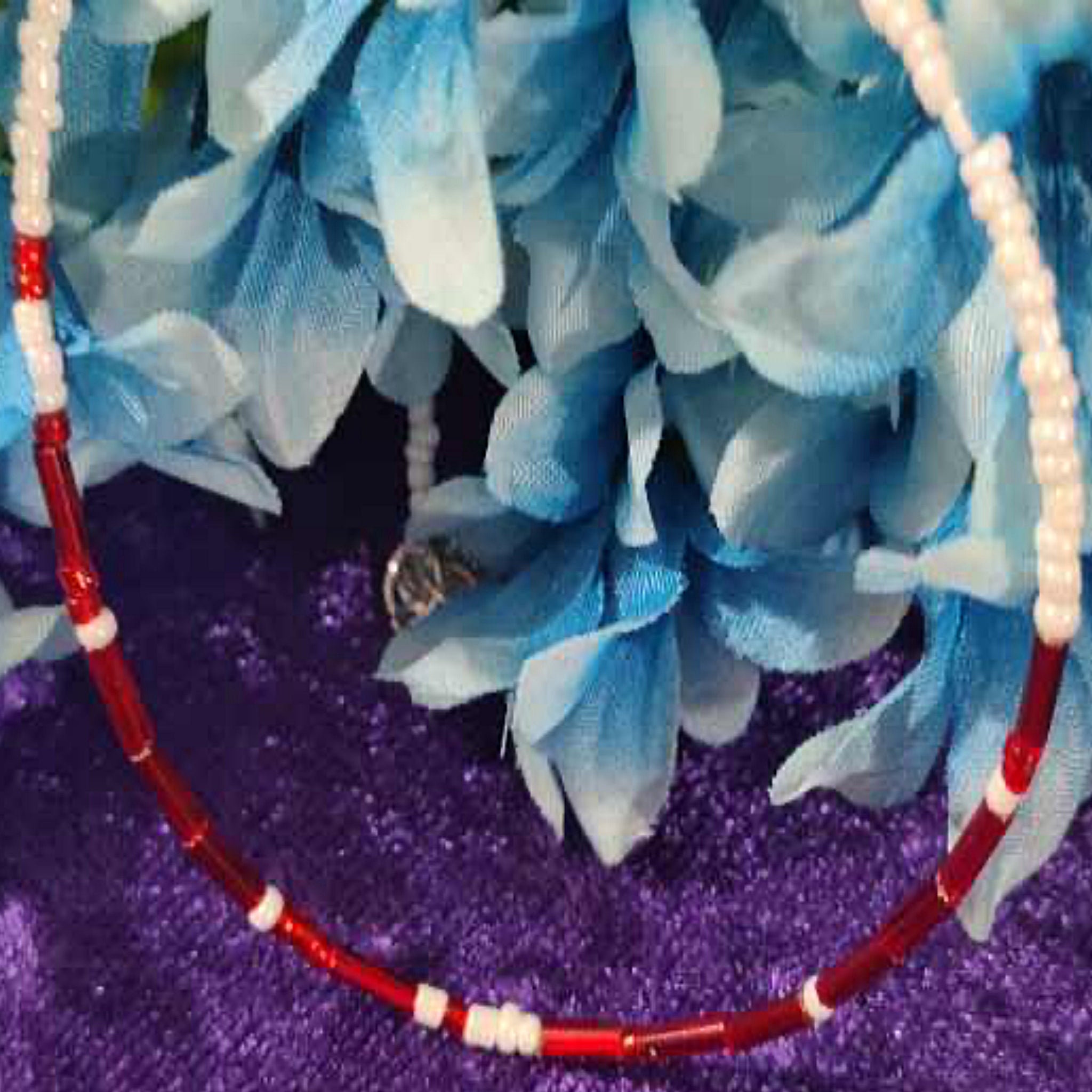 A handcrafted seed bead necklace featuring the phrase 'I Love You' in Morse Code, showcasing intricate beadwork and a delicate design.