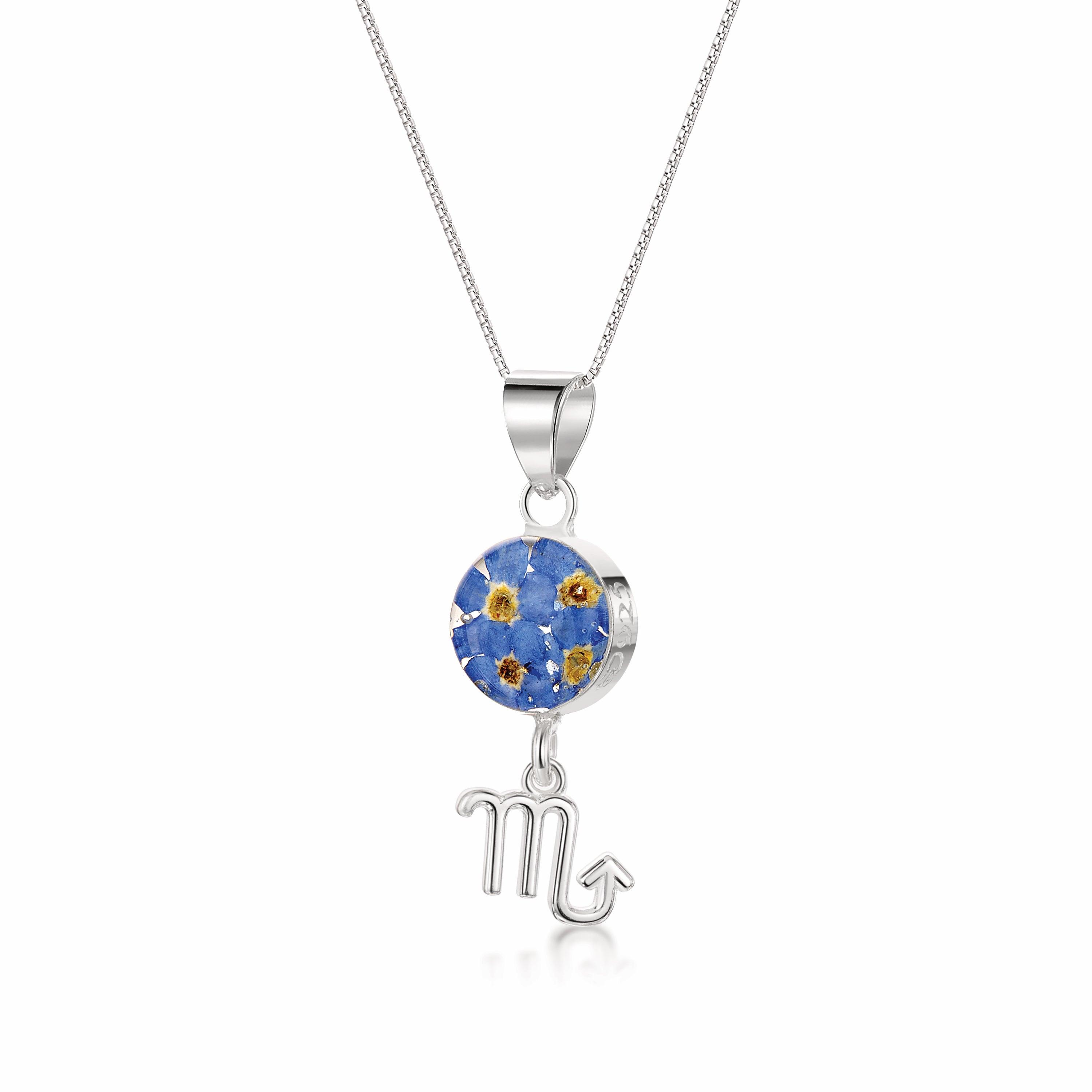 A stunning Scorpio Necklace featuring a sterling silver pendant with real preserved flowers and an intricately designed Scorpio zodiac charm.