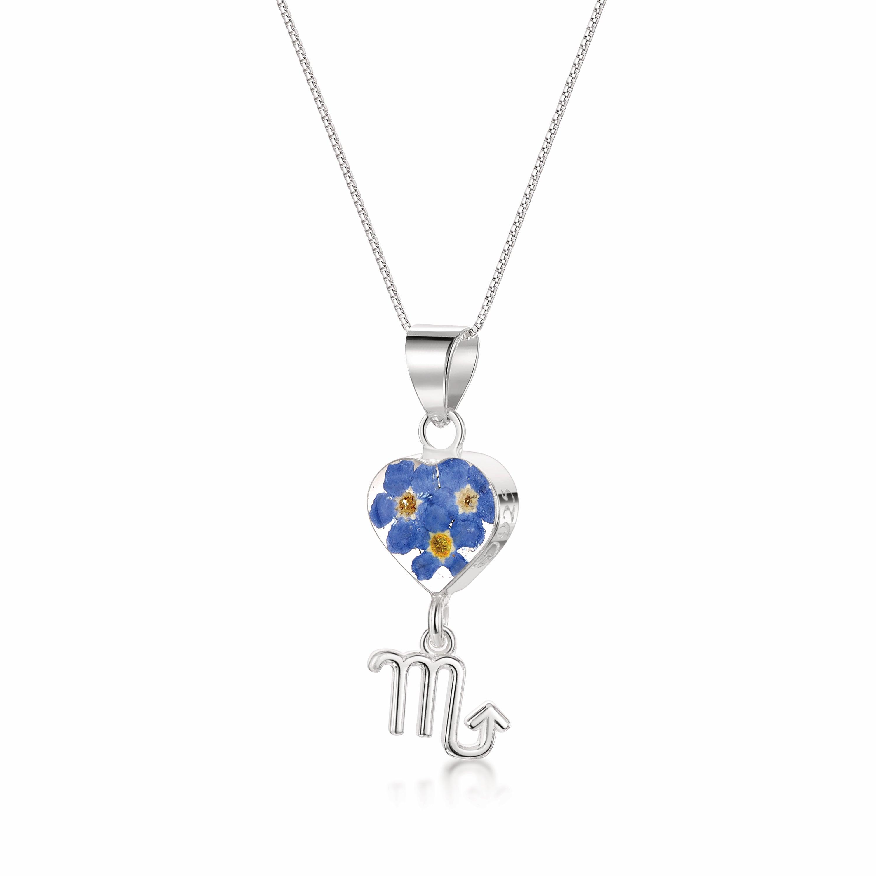 A stunning Scorpio Necklace featuring a sterling silver pendant with real preserved flowers and an intricately designed Scorpio zodiac charm.