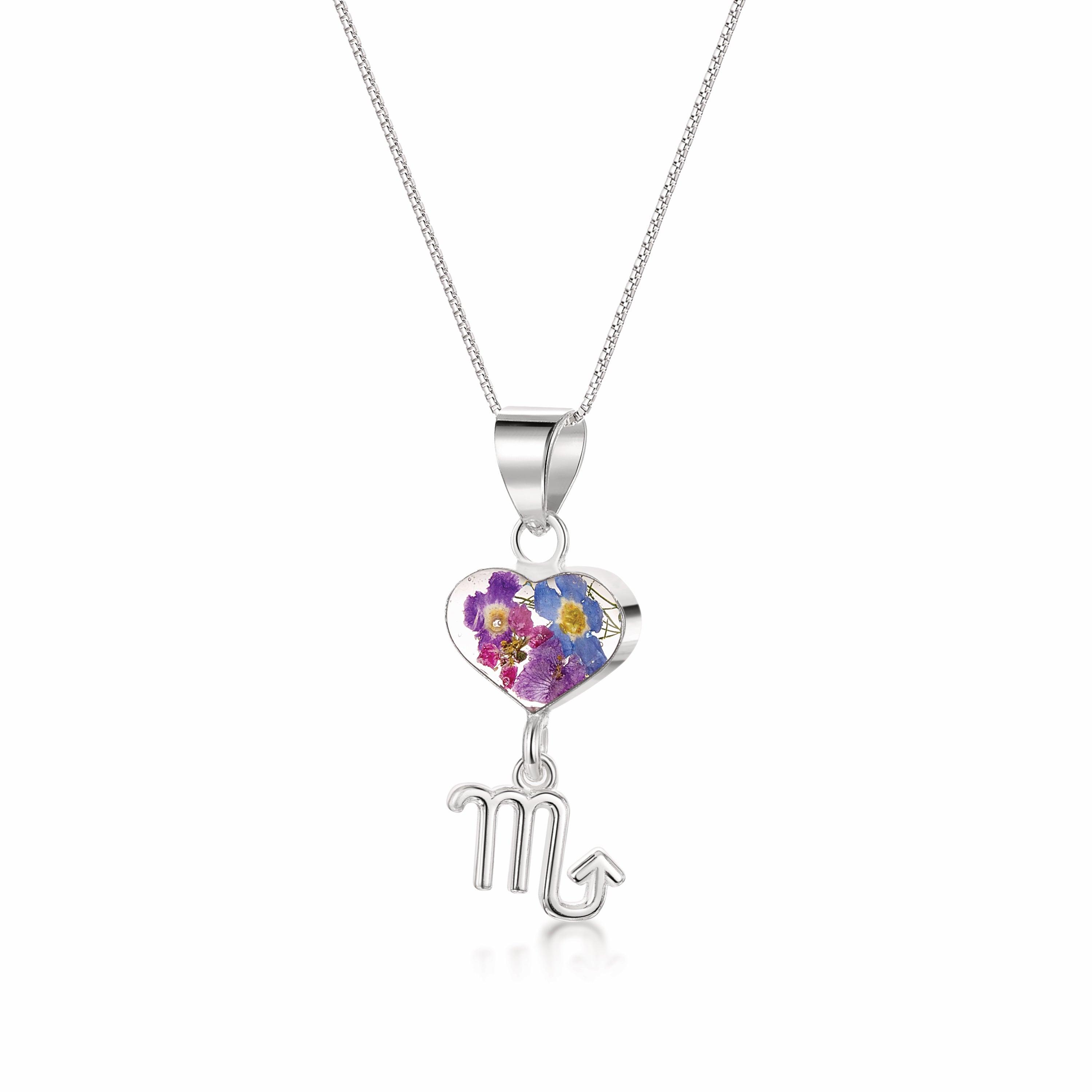 A stunning Scorpio Necklace featuring a sterling silver pendant with real preserved flowers and an intricately designed Scorpio zodiac charm.