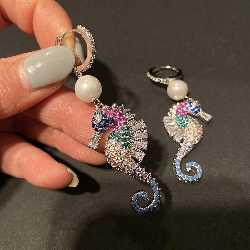 A pair of elegant seahorse earrings featuring cubic zirconia and simulated pearl drops, designed for women.