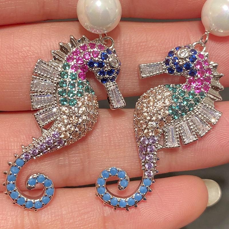 A pair of elegant seahorse earrings featuring cubic zirconia and simulated pearl drops, designed for women.