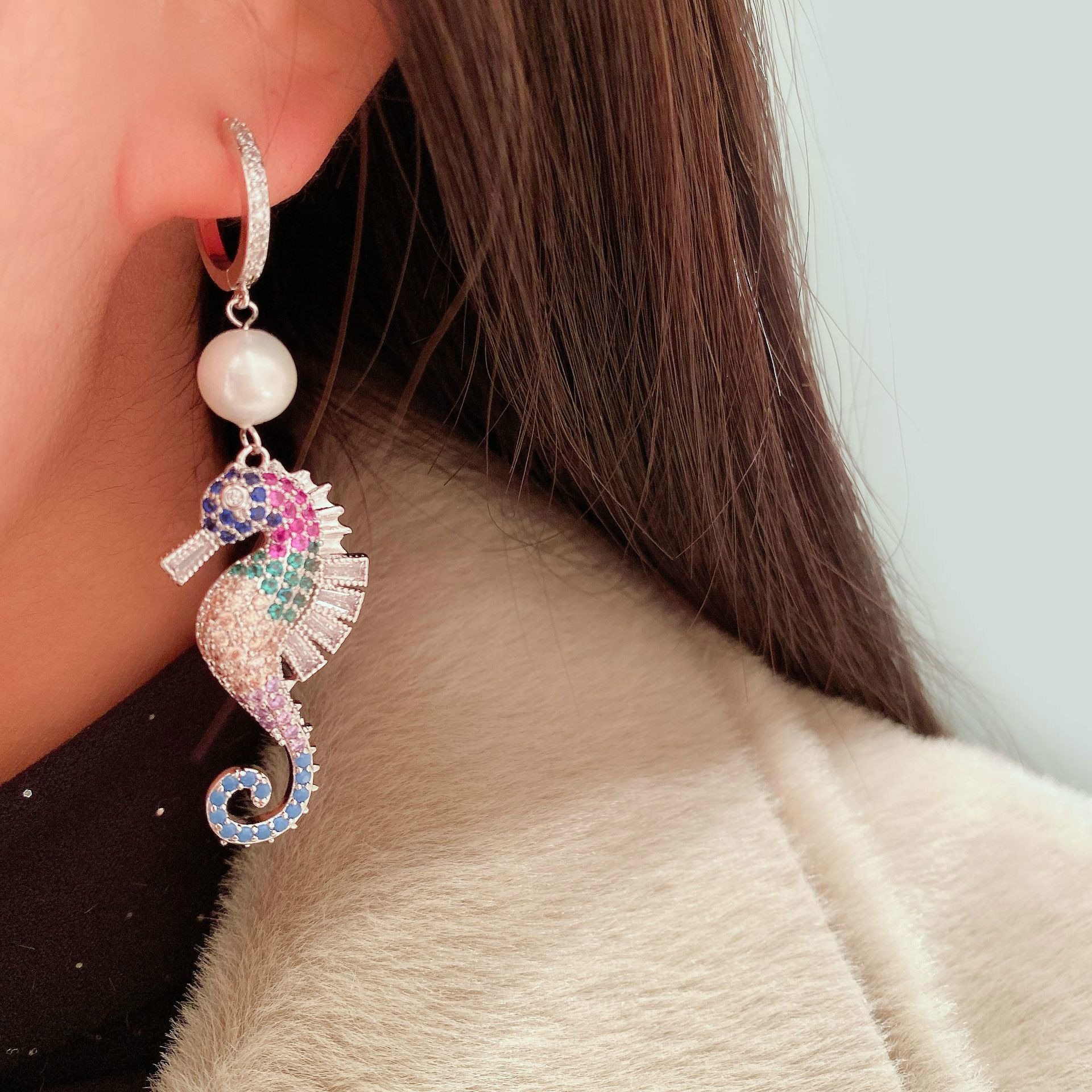 A pair of elegant seahorse earrings featuring cubic zirconia and simulated pearl drops, designed for women.