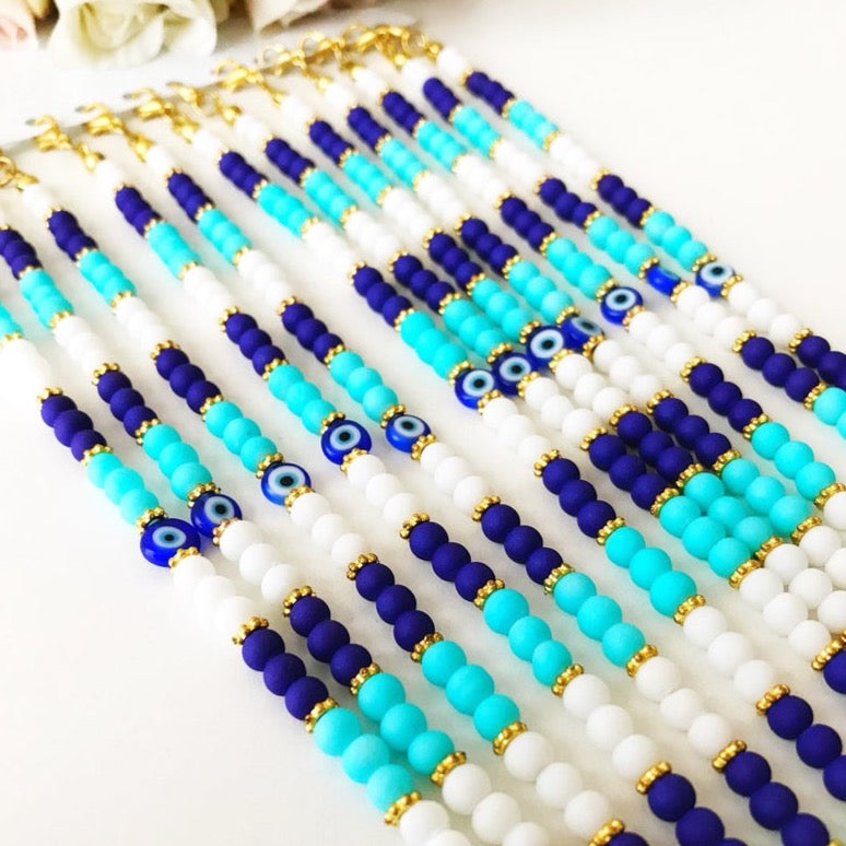 Handmade Seed Beads Bracelet featuring a blue Evil Eye charm, crafted with Miyuki beads, adjustable length, and vibrant turquoise colors.