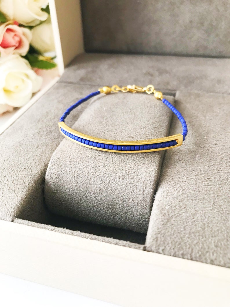 Handmade Seed Beads Bracelet featuring blue Miyuki beads and a delicate gold chain, symbolizing luck and protection.