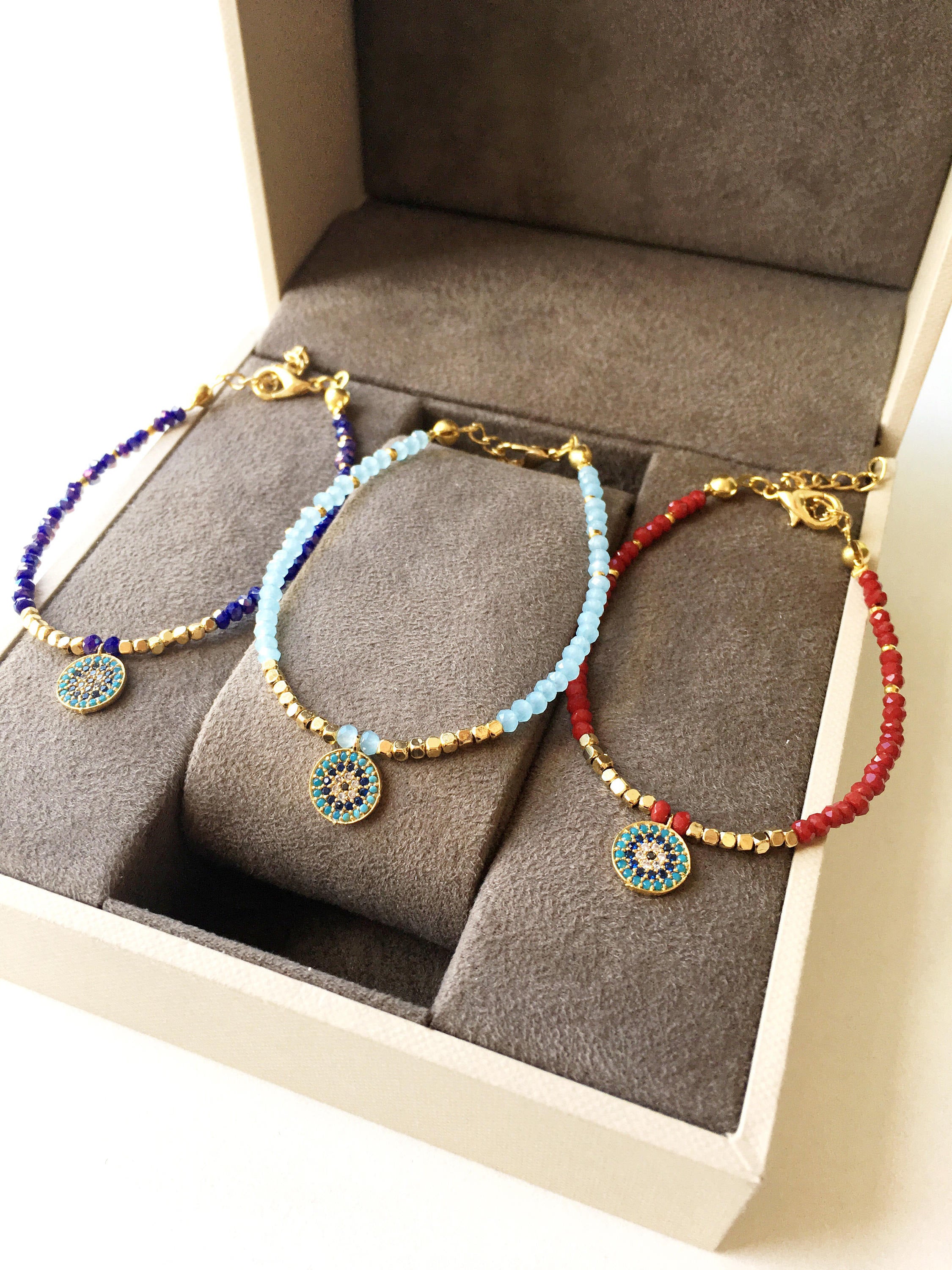 Handmade Miyuki Evil Eye Bracelet featuring vibrant turquoise, red, and blue seed beads with a protective charm.