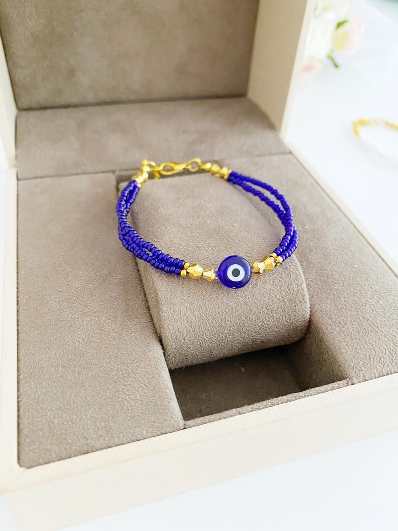 Handmade Seed Beads Evil Eye Bracelet featuring colorful Miyuki beads in blue, red, turquoise, and white.