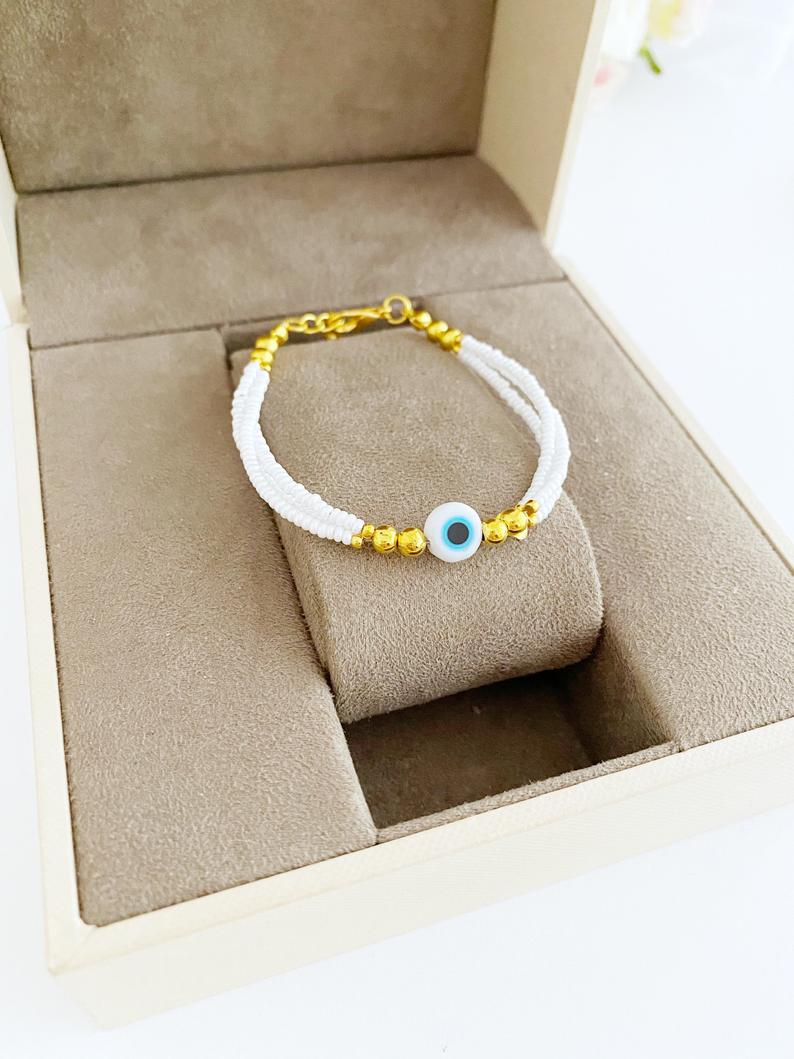 Handmade Seed Beads Evil Eye Bracelet featuring colorful Miyuki beads in blue, red, turquoise, and white.