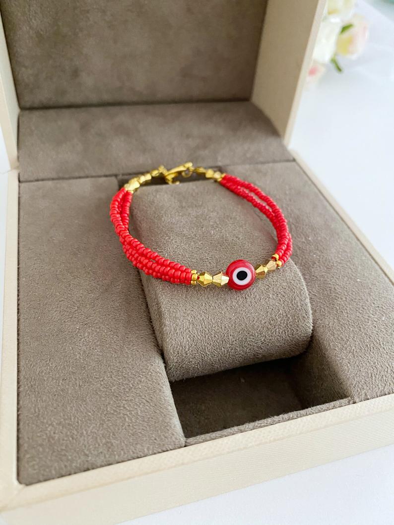 Handmade Seed Beads Evil Eye Bracelet featuring colorful Miyuki beads in blue, red, turquoise, and white.