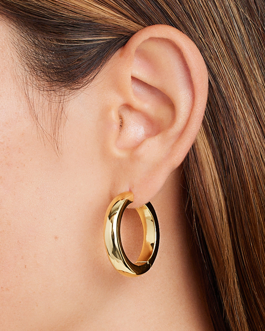 Elegant 14k gold hoop earrings designed for layering and styling.