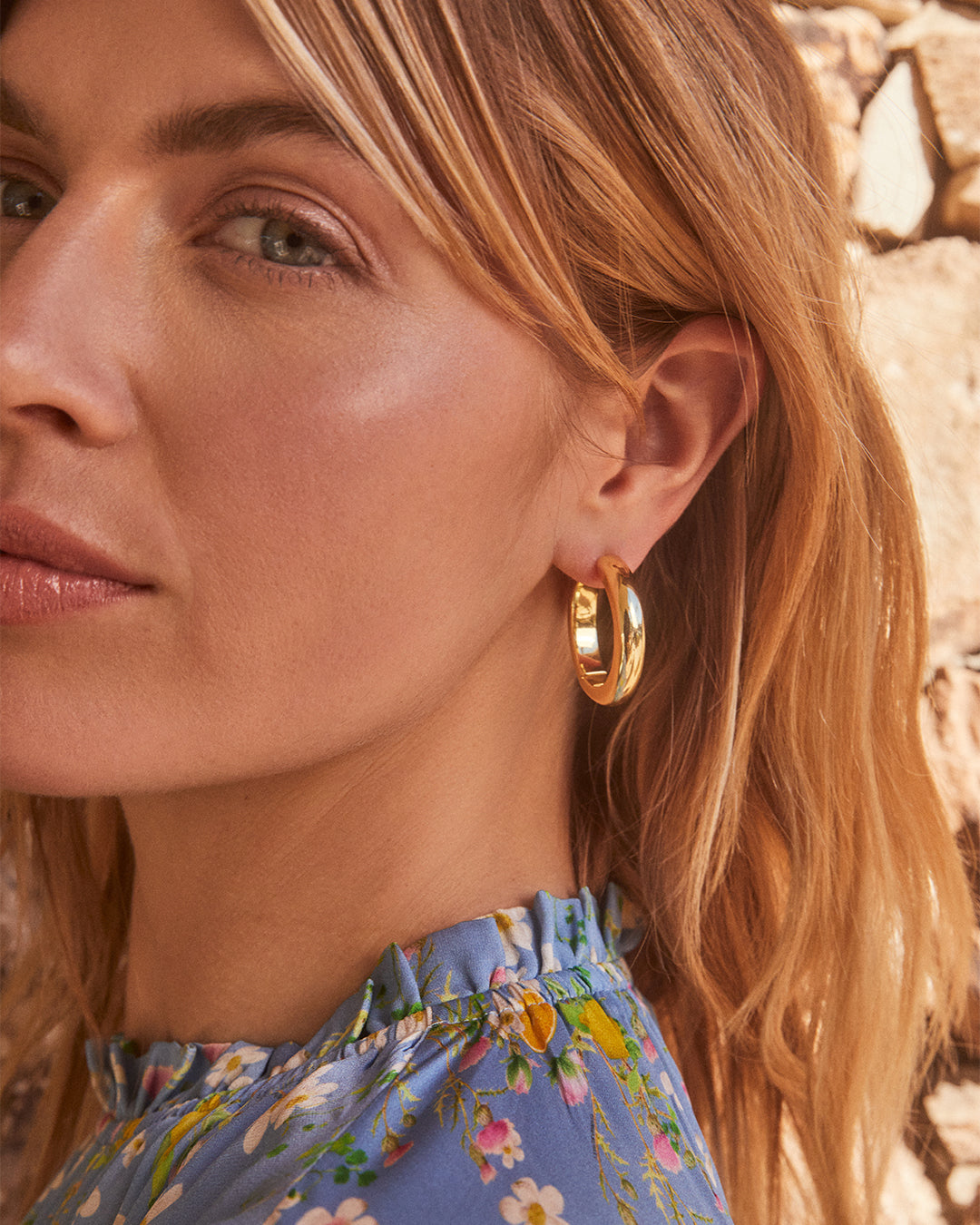 Elegant 14k gold hoop earrings designed for layering and styling.