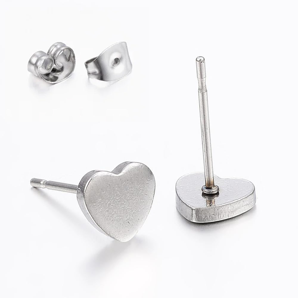 She Sparkles Silver Heart Stud Earrings made from hypoallergenic 304 stainless steel, elegantly displayed on a gift card.
