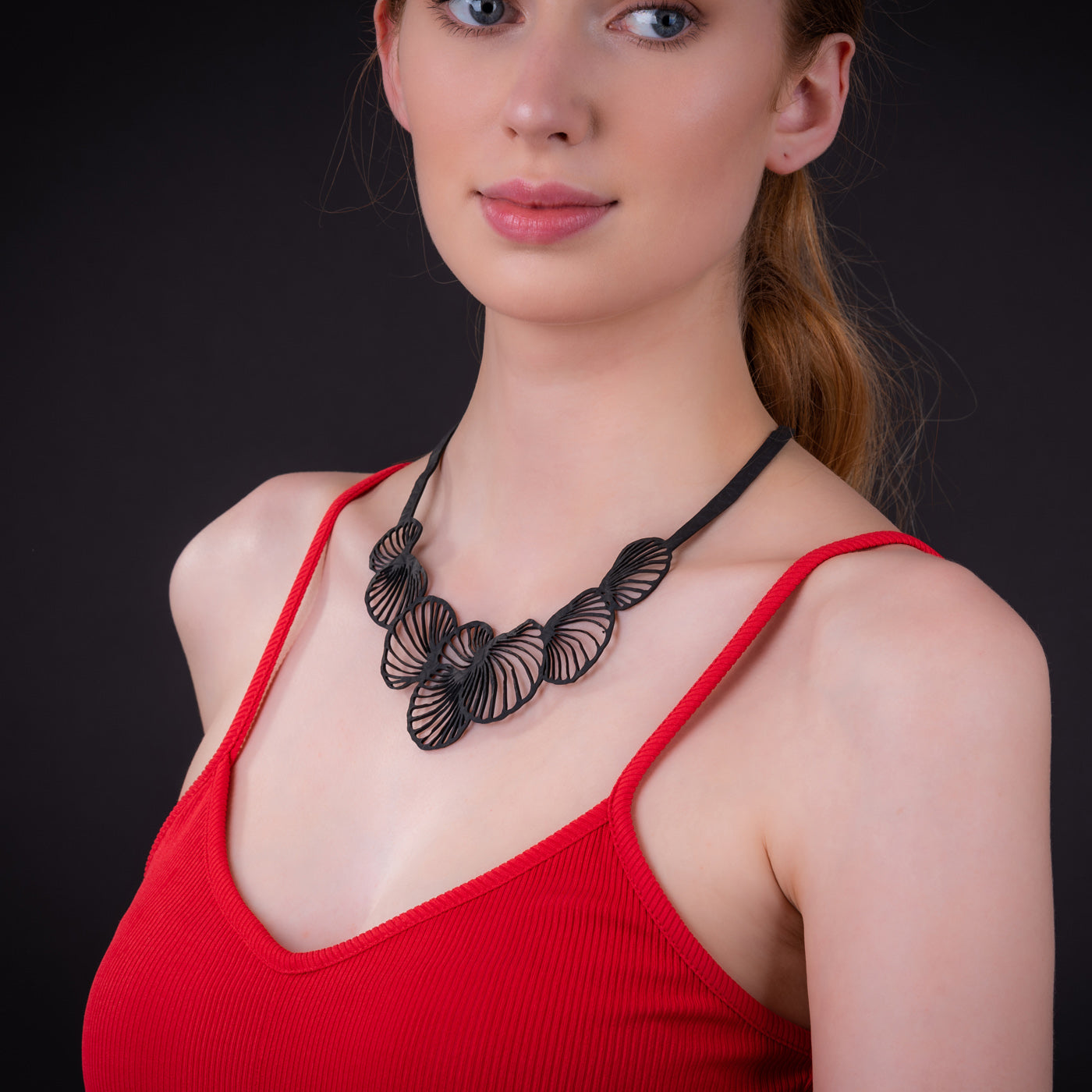 Handcrafted Shell Inner Tube Necklace made from recycled rubber, featuring unique patterns and a comfortable design, presented in a luxury gift box.