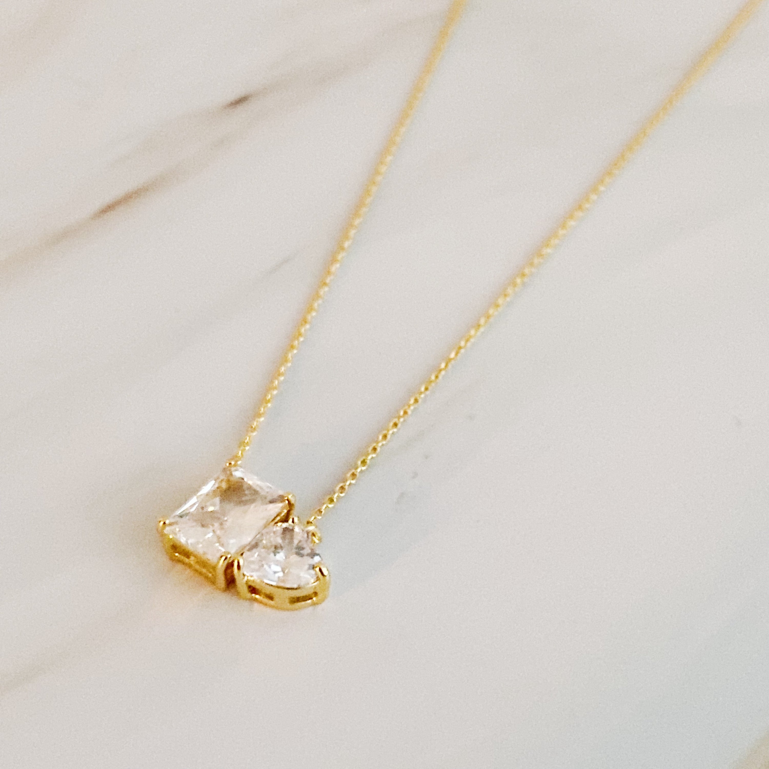 A delicate Shines Next To You Necklace featuring 18k gold plating and sparkling cubic zirconia, elegantly displayed on a soft background.