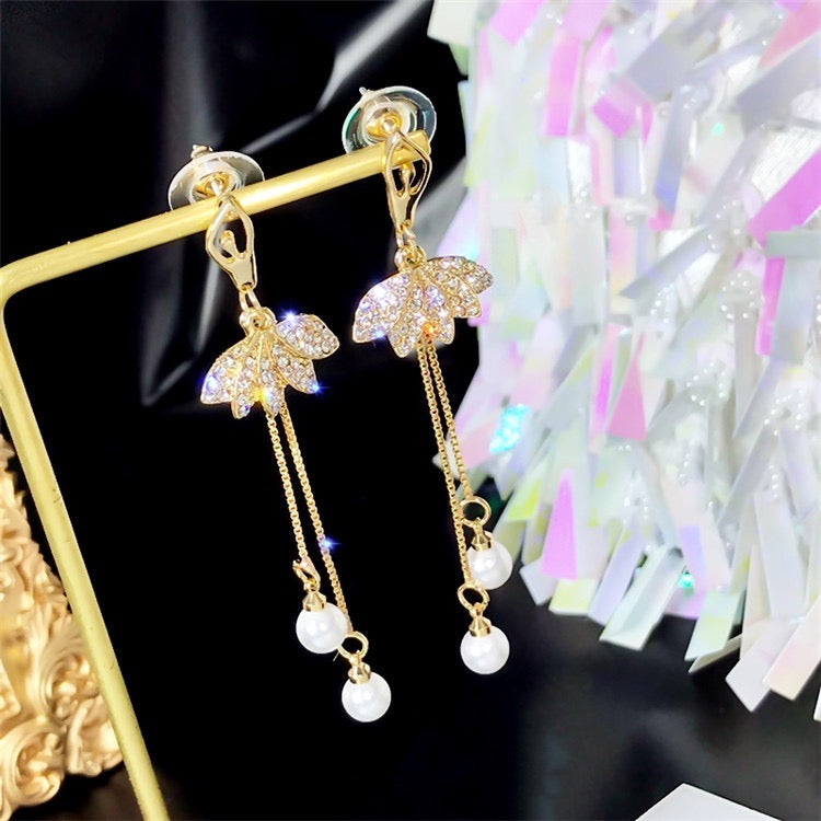 Elegant Shinning Lotus Long Earrings featuring dual pear tassels, crafted from alloy and rhinestones.