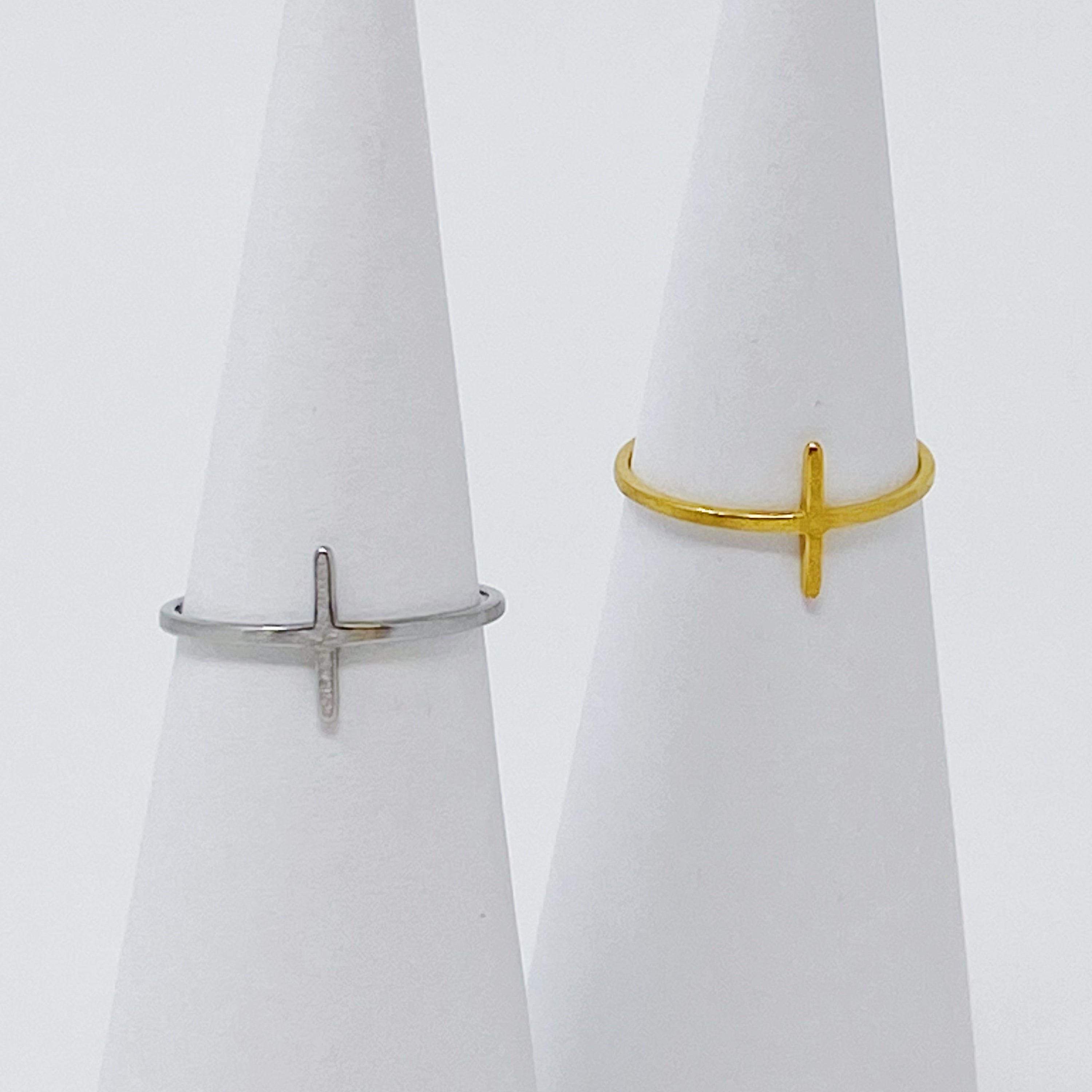 A slim dainty side cross ring made of stainless steel with 18K gold plating, showcasing its elegant design.