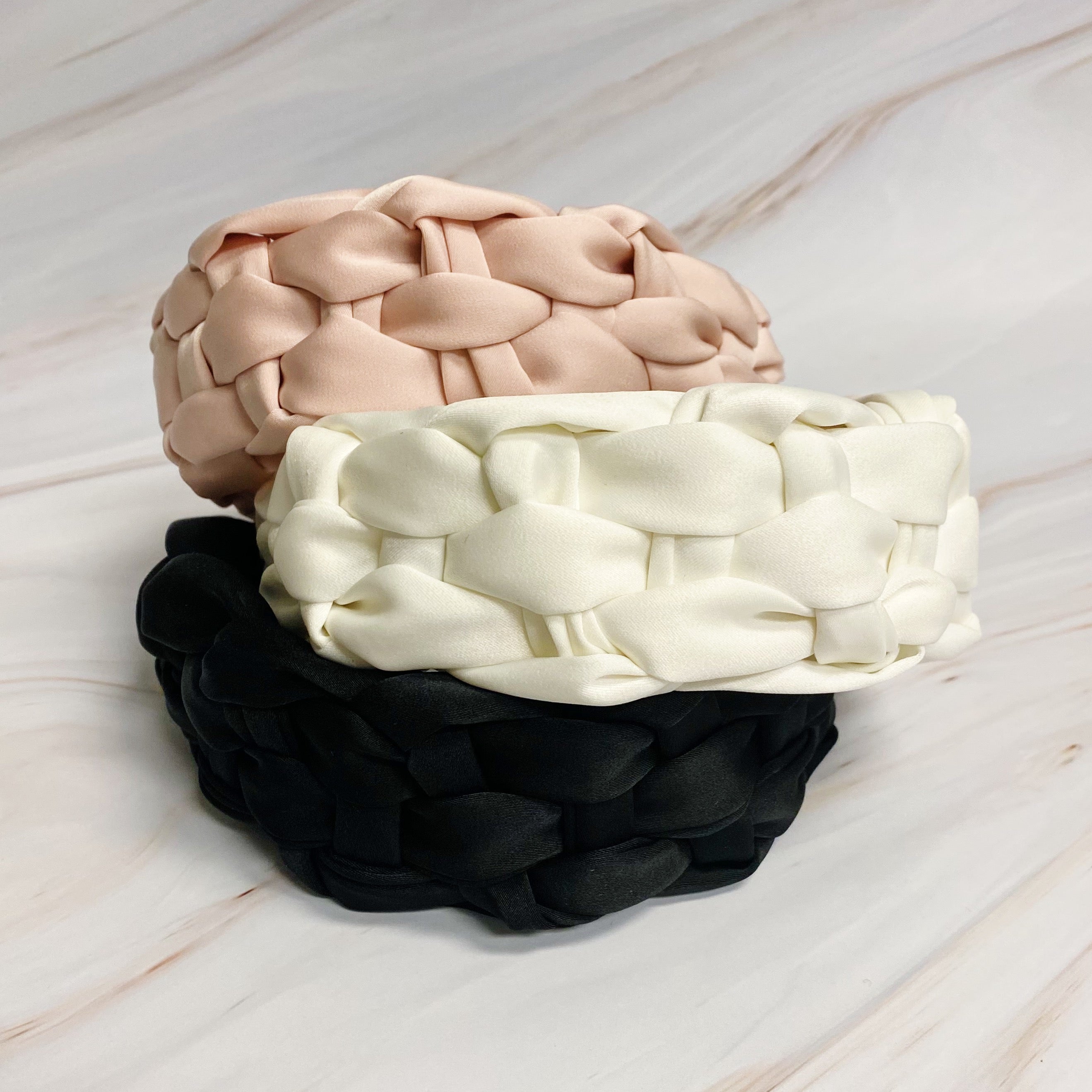 A luxurious silky woven headband featuring a hand-woven design, perfect for stylish comfort.