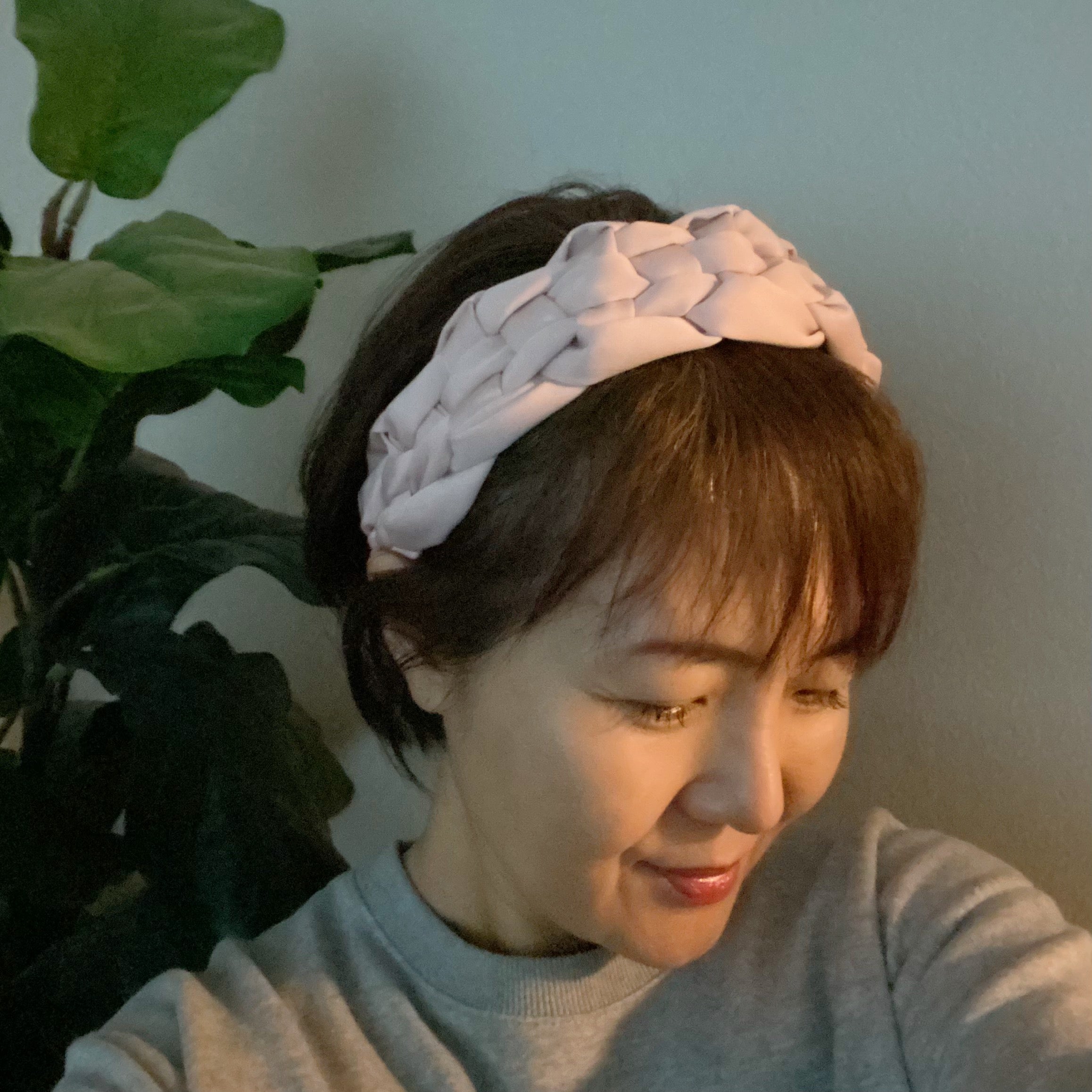 A luxurious silky woven headband featuring a hand-woven design, perfect for stylish comfort.