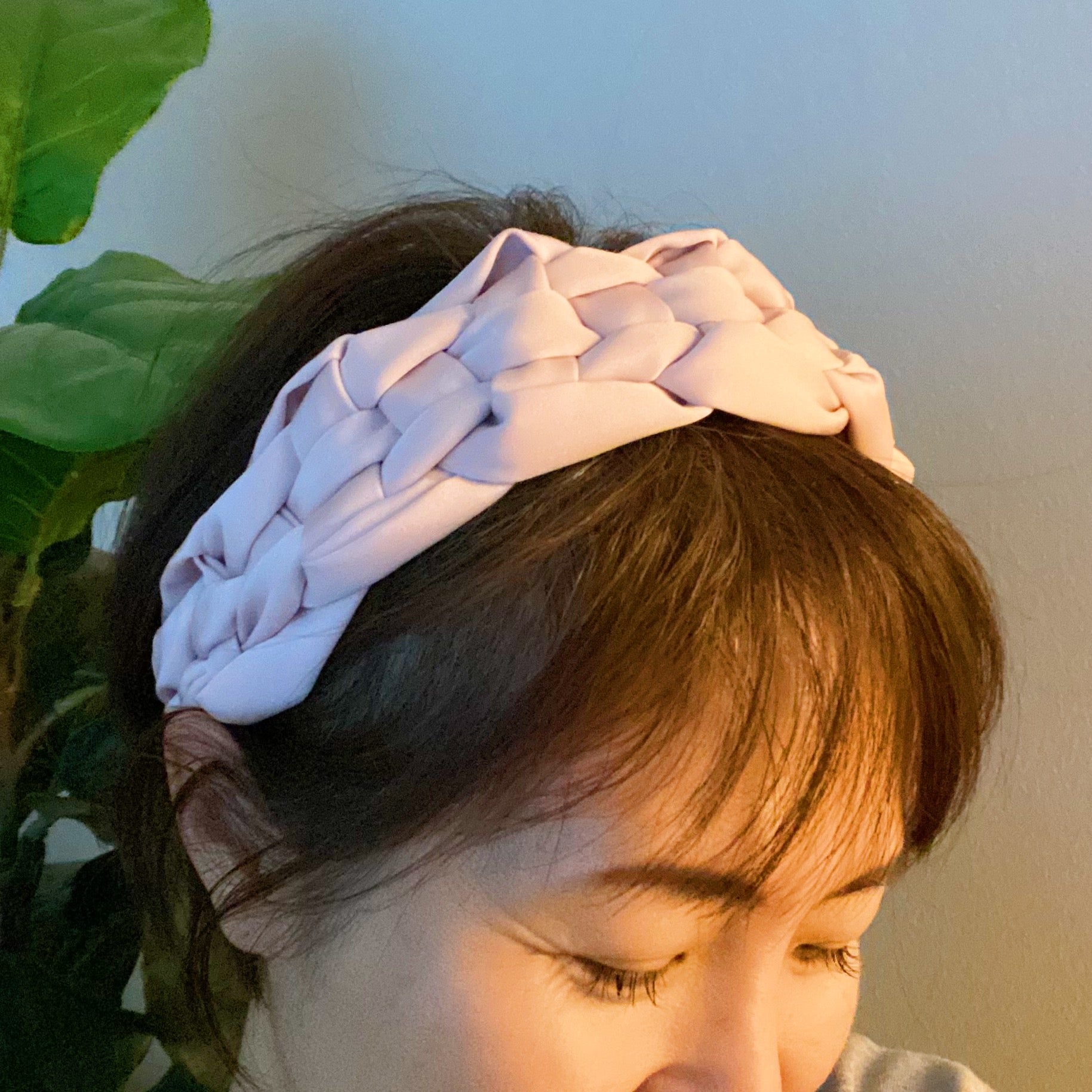 A luxurious silky woven headband featuring a hand-woven design, perfect for stylish comfort.