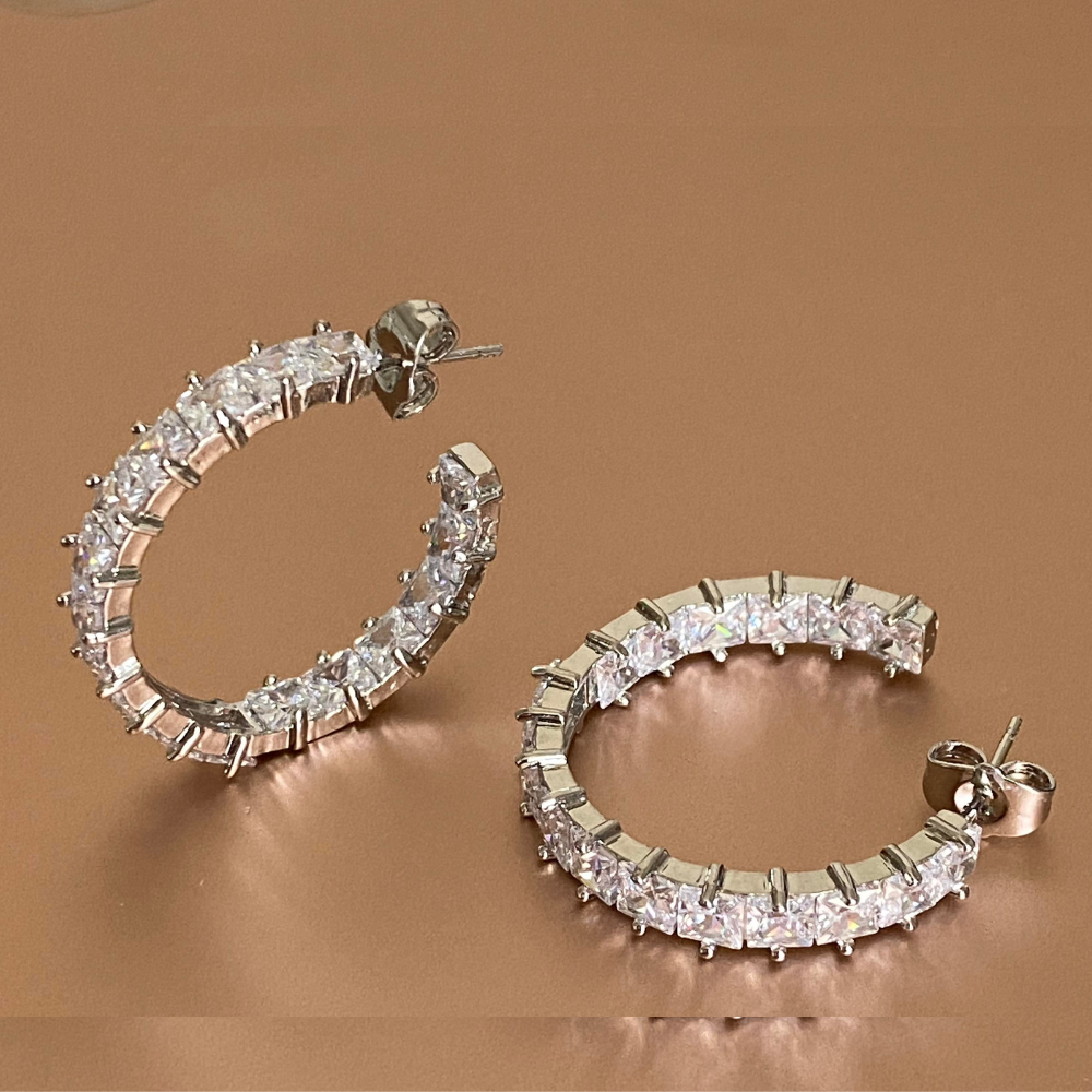 Elegant silver hoop earrings featuring princess cut white diamond cubic zirconia stones, perfect for any occasion.
