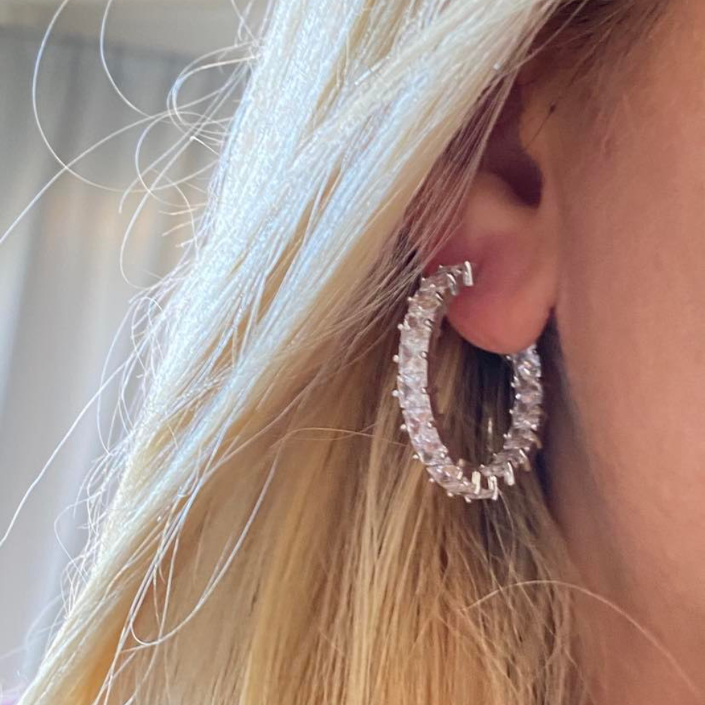 Elegant silver hoop earrings featuring princess cut white diamond cubic zirconia stones, perfect for any occasion.