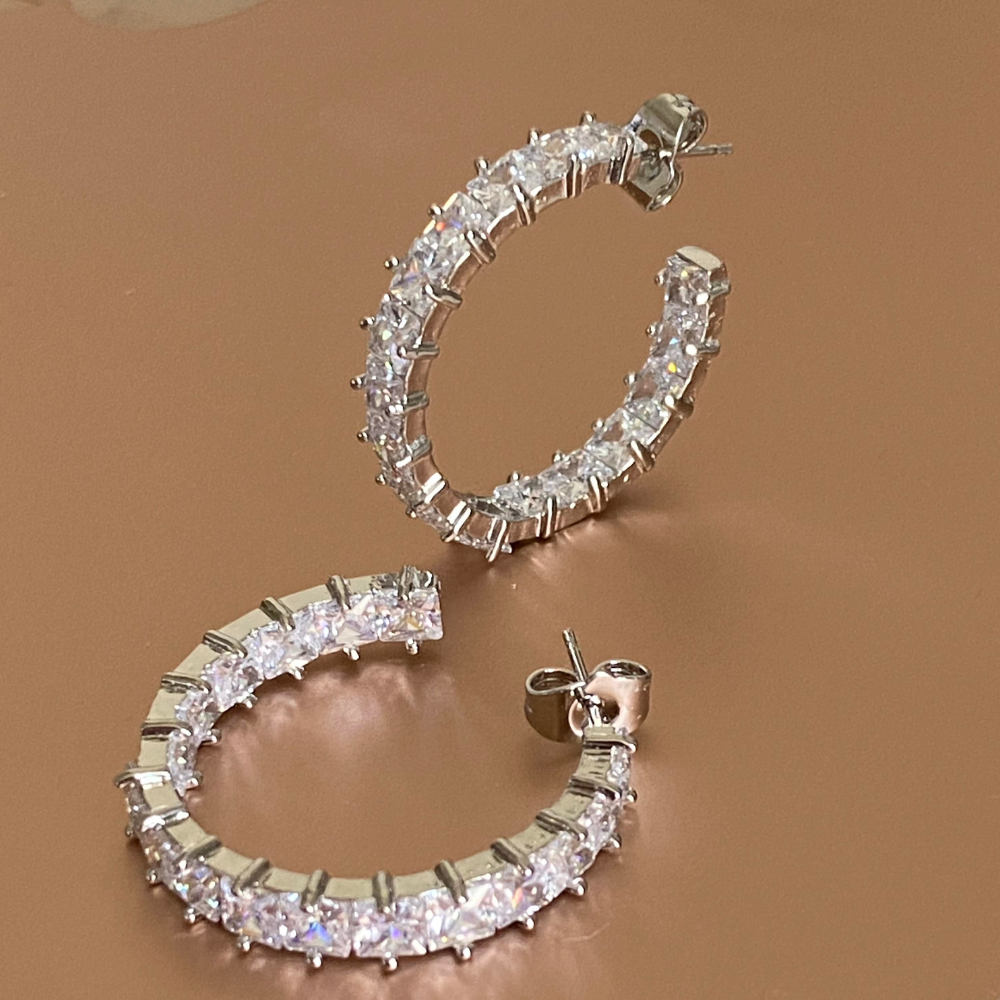 Elegant silver hoop earrings featuring princess cut white diamond cubic zirconia stones, perfect for any occasion.