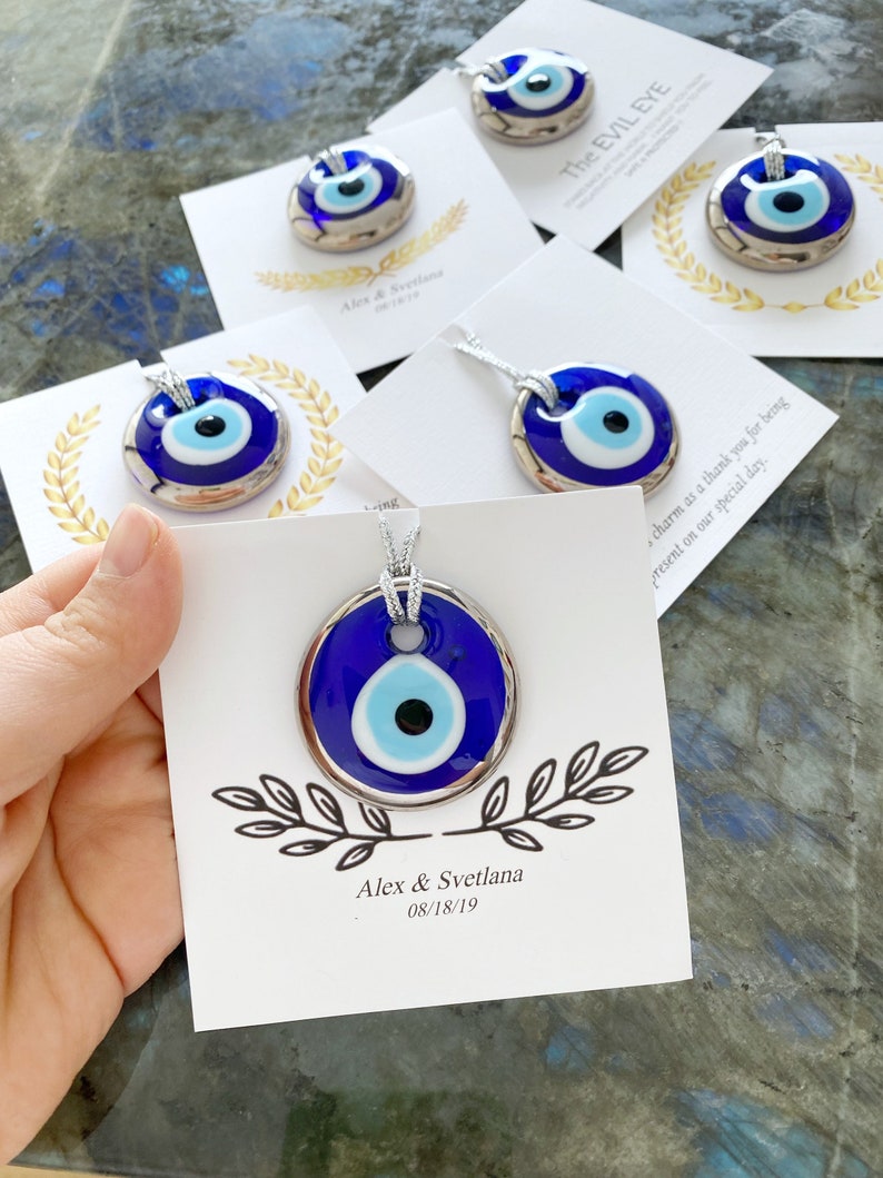 A collection of silver evil eye beads displayed elegantly, showcasing their intricate glass design, perfect for wedding favors.