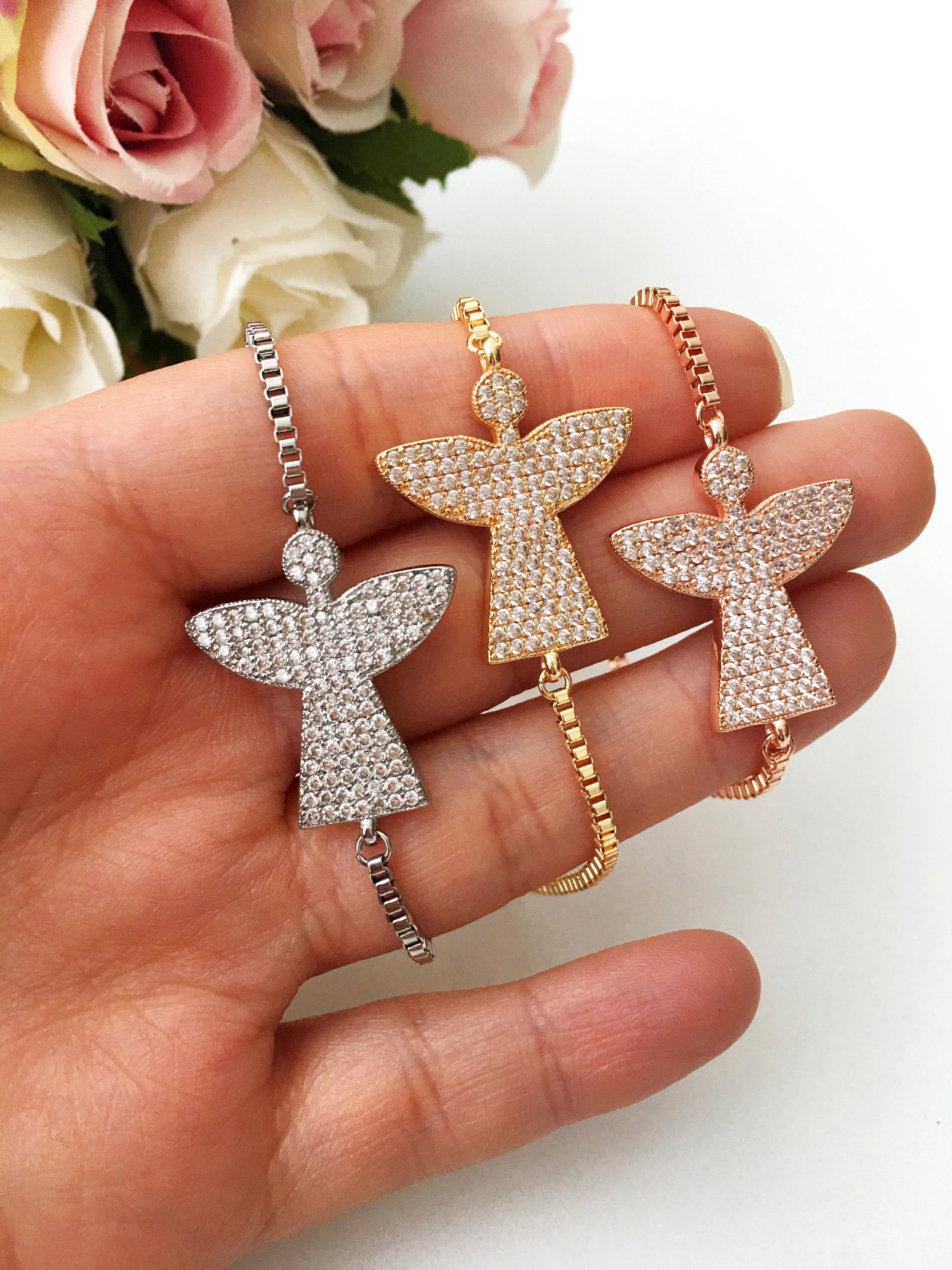 A beautiful set of handmade silver evil eye bracelets, featuring various designs including safety pin, baguette, and zirconia styles, all adjustable for comfort.