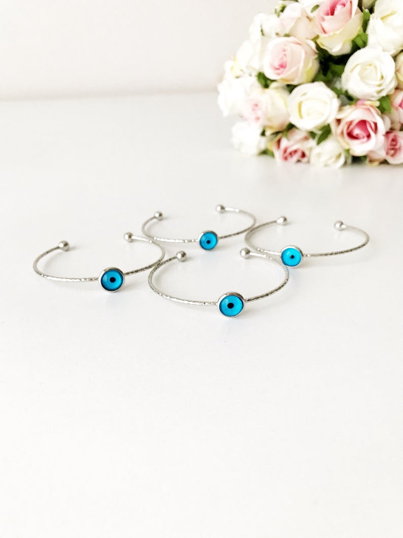 A delicate silver evil eye bracelet featuring a movable oval charm, crafted from tarnish-resistant stainless steel.