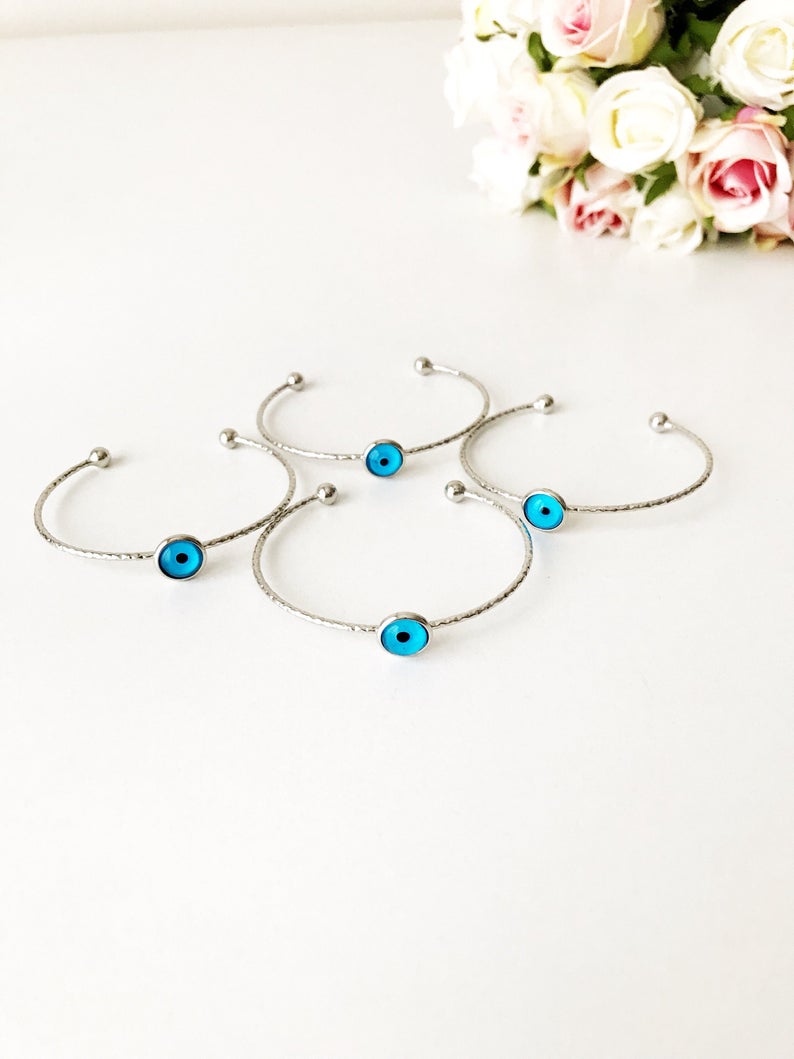 A delicate silver evil eye bracelet featuring a movable oval charm, crafted from tarnish-resistant stainless steel.