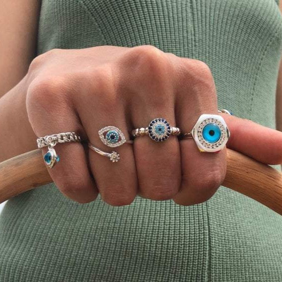 A beautiful silver adjustable ring featuring a blue evil eye bead and a zircon evil eye bead, symbolizing protection and good luck.