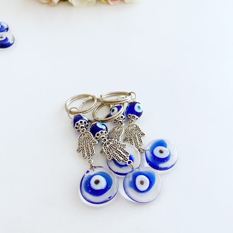 Silver Hamsa Evil Eye Keychain featuring a blue glass bead, elegantly designed with a hamsa hand charm.