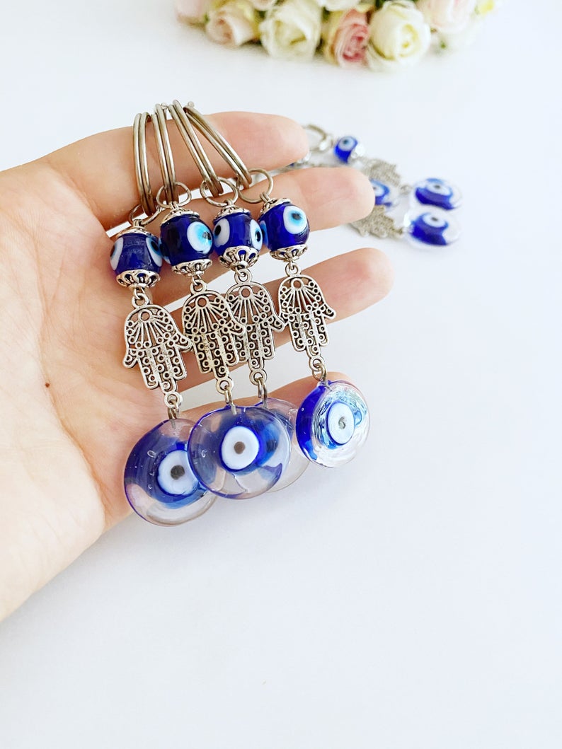 Silver Hamsa Evil Eye Keychain featuring a blue glass bead, elegantly designed with a hamsa hand charm.