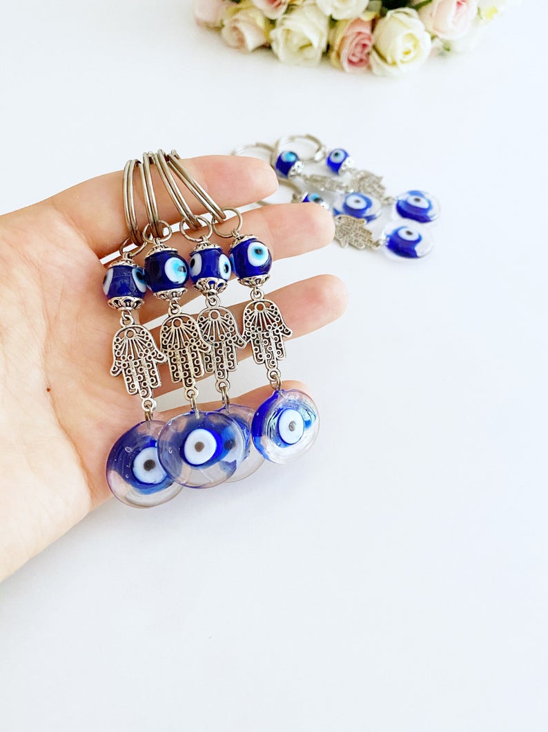 Silver Hamsa Evil Eye Keychain featuring a blue glass bead, elegantly designed with a hamsa hand charm.