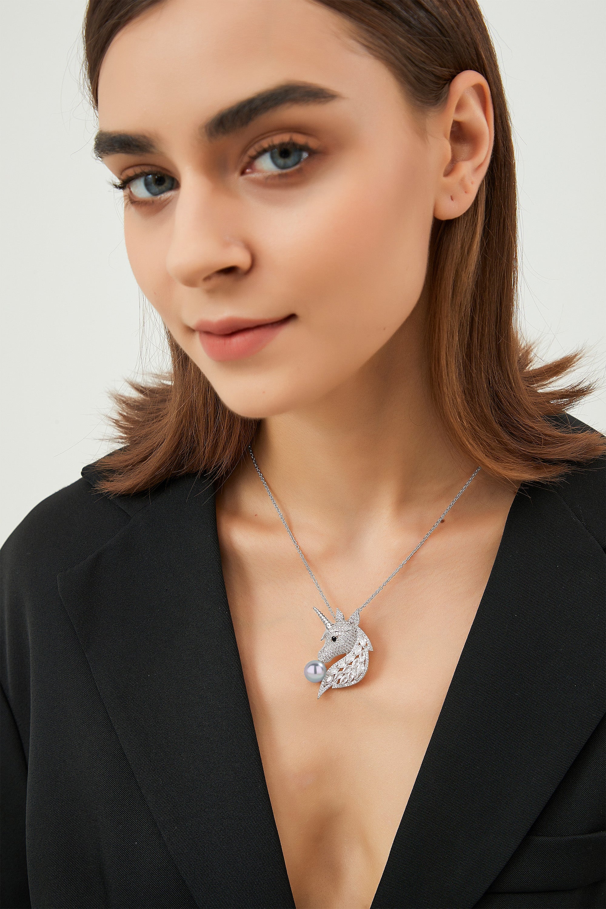Silver Pavé Unicorn Brooch and Necklace Set featuring Swarovski crystals and a faux Tahitian pearl, showcasing a mythical unicorn design.
