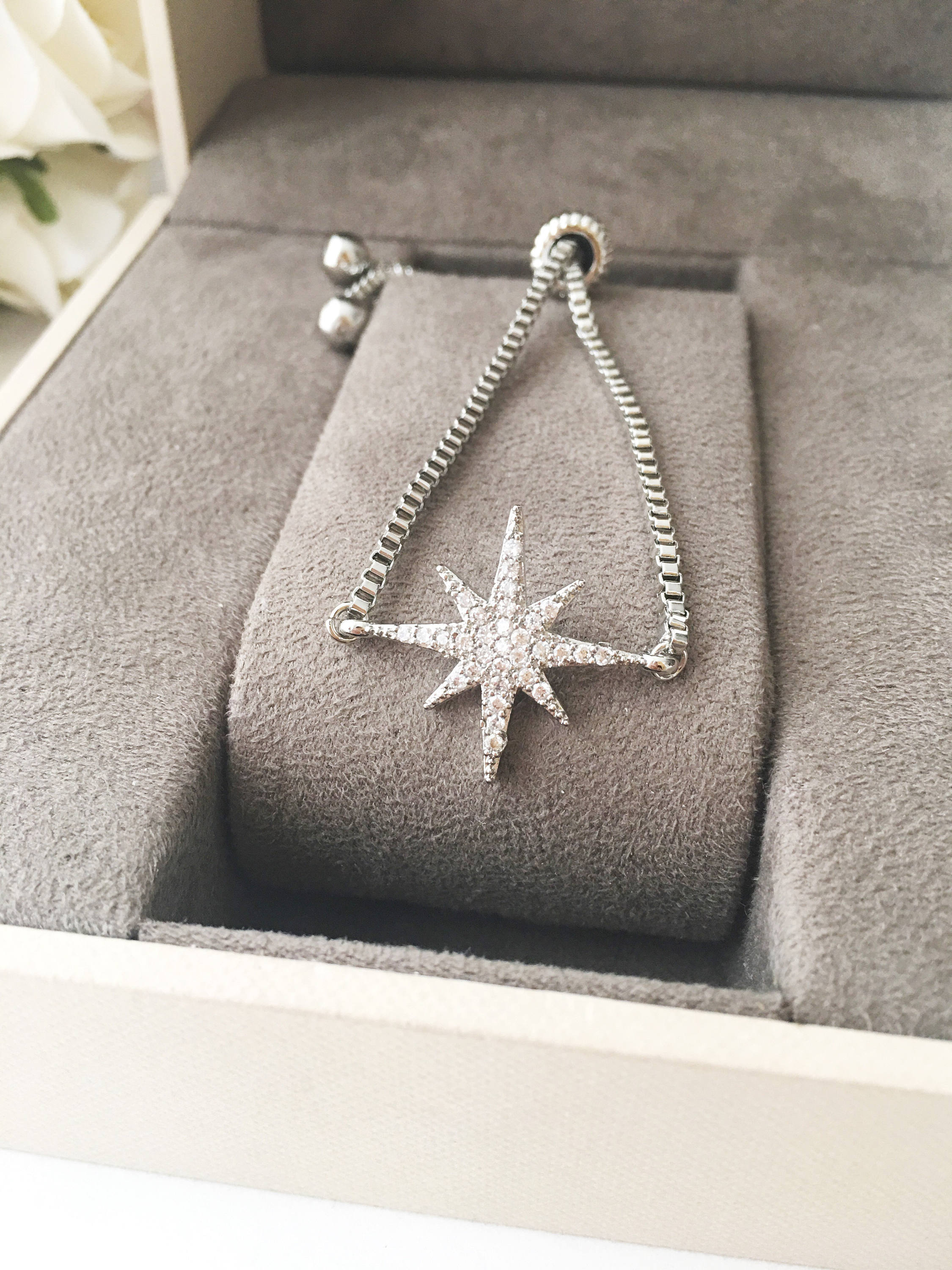 A beautiful handmade silver star bracelet featuring a silver star charm, adjustable design, and tarnish-resistant stainless steel material.
