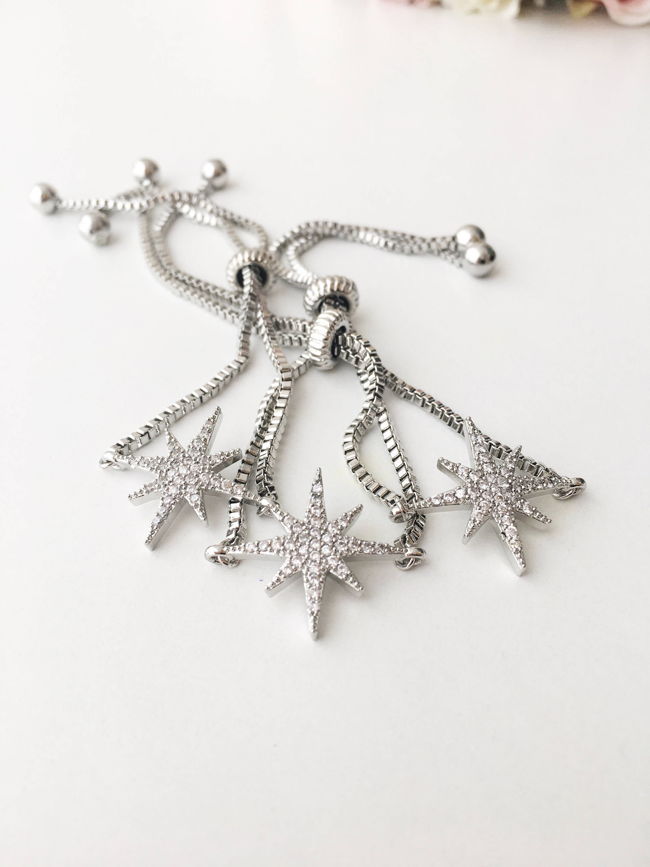 A beautiful handmade silver star bracelet featuring a silver star charm, adjustable design, and tarnish-resistant stainless steel material.