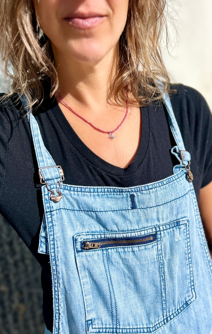 Silver Starburst Bling Magenta Stretchy Seed Bead Necklace featuring magenta Czech glass beads and a metallic silver starburst charm.