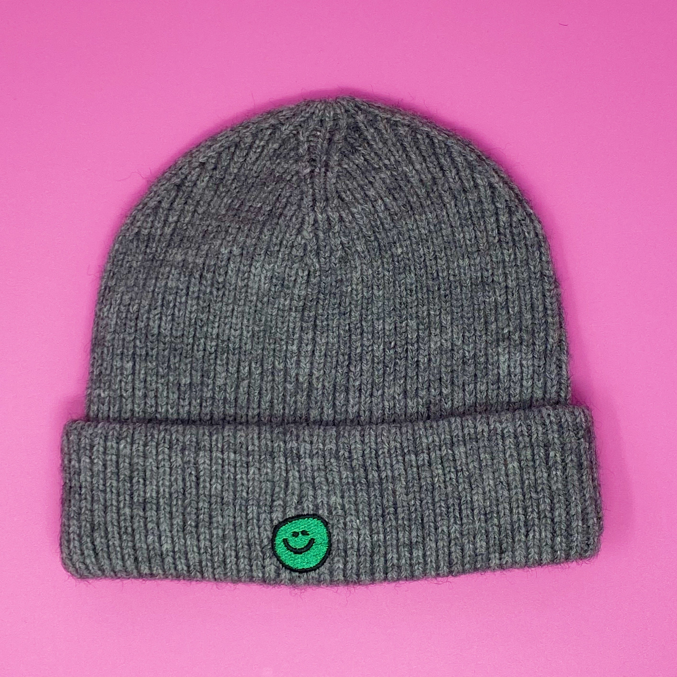 Simply Smile Beanie featuring a small happy face embroidery, made of soft acrylic material.