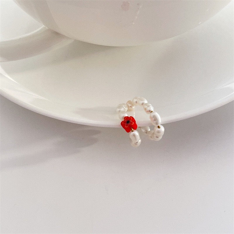 A pair of elegant ear clips featuring single coloured crystals and artificial pearls, crafted from alloy, showcasing a stylish design.