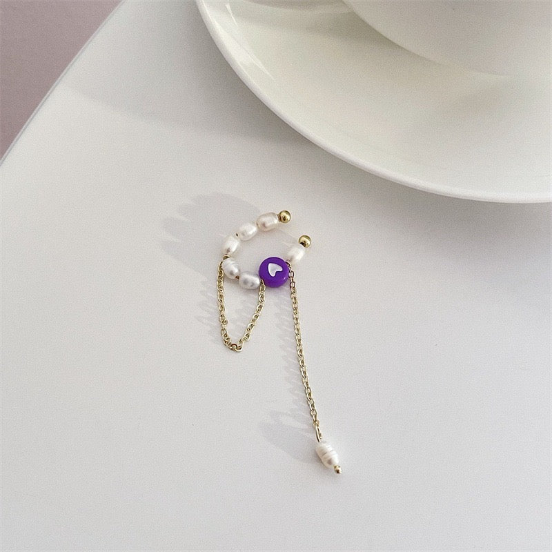 A pair of elegant ear clips featuring single coloured crystals and artificial pearls, crafted from alloy, showcasing a stylish design.