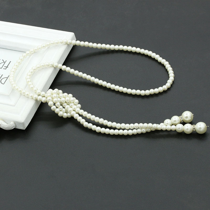 A beautiful single layer long necklace made of pearls, adorned with rhinestones, showcasing elegance and style.