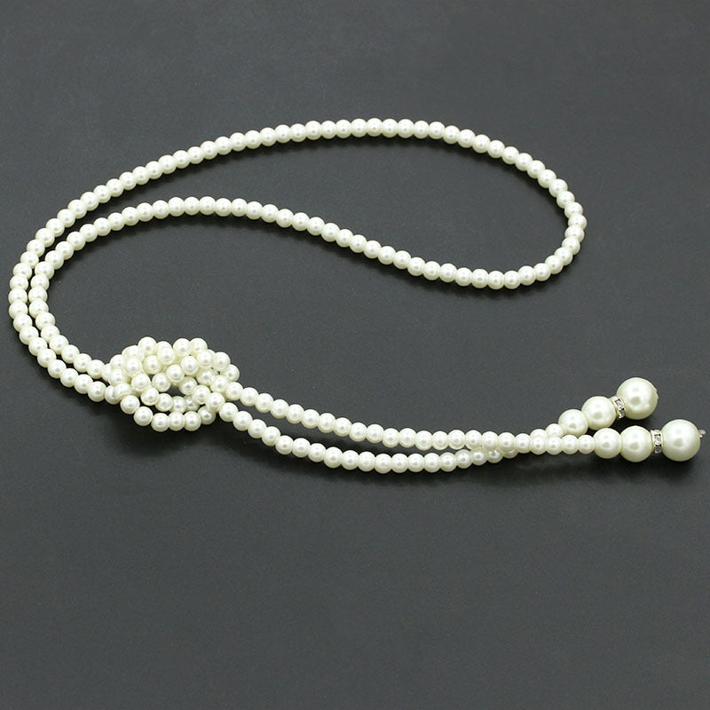 A beautiful single layer long necklace made of pearls, adorned with rhinestones, showcasing elegance and style.