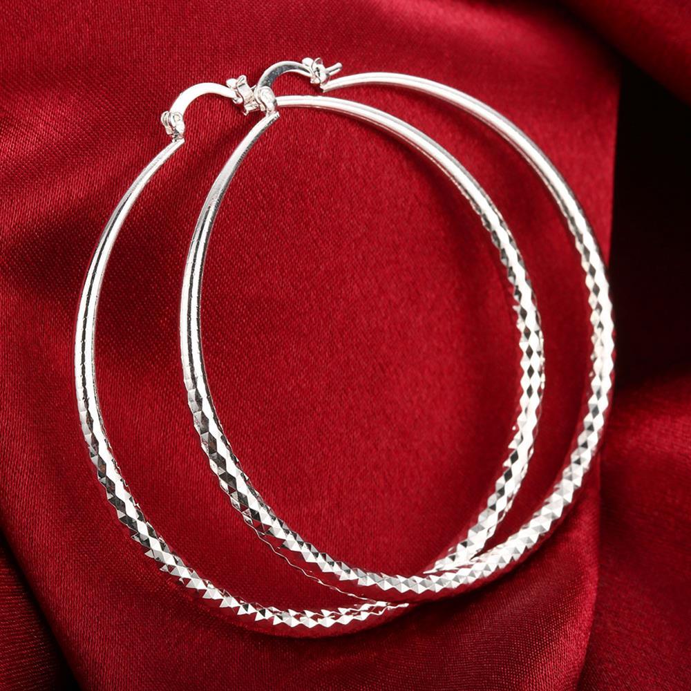 Sleek silver plated Roman Ingrain classic hoop earrings, showcasing a unique design and elegant finish.
