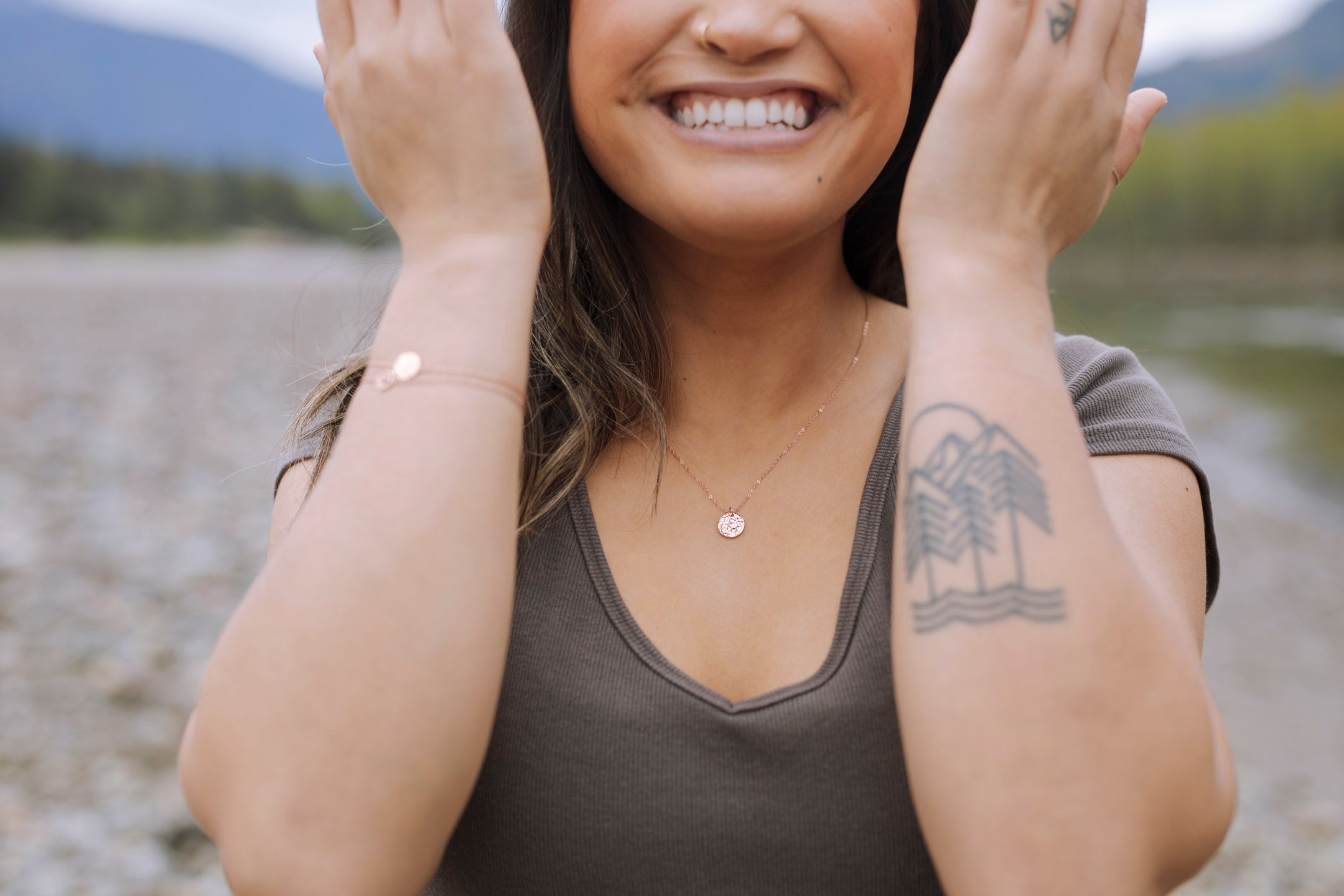 A delicate small textured circle necklace that sparkles like the sun on water, available in sterling silver, rose gold, and yellow gold finishes.