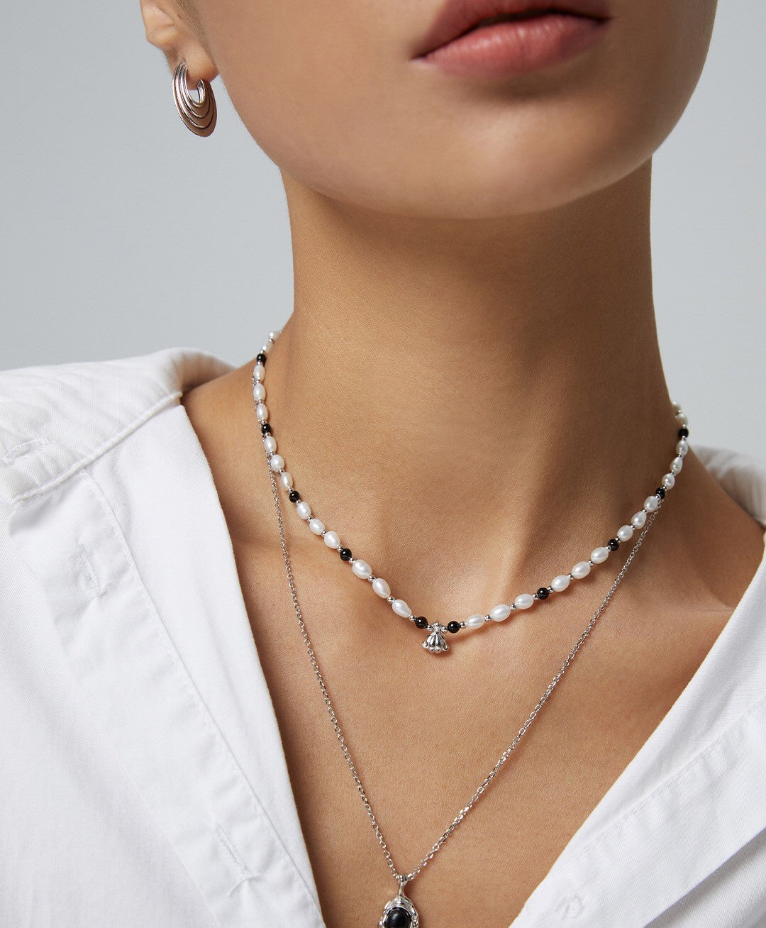 A stunning Spaced Black Onyx Pearl Pendant Necklace featuring natural pearls, black onyx, and gold vermeil accents, elegantly displayed.