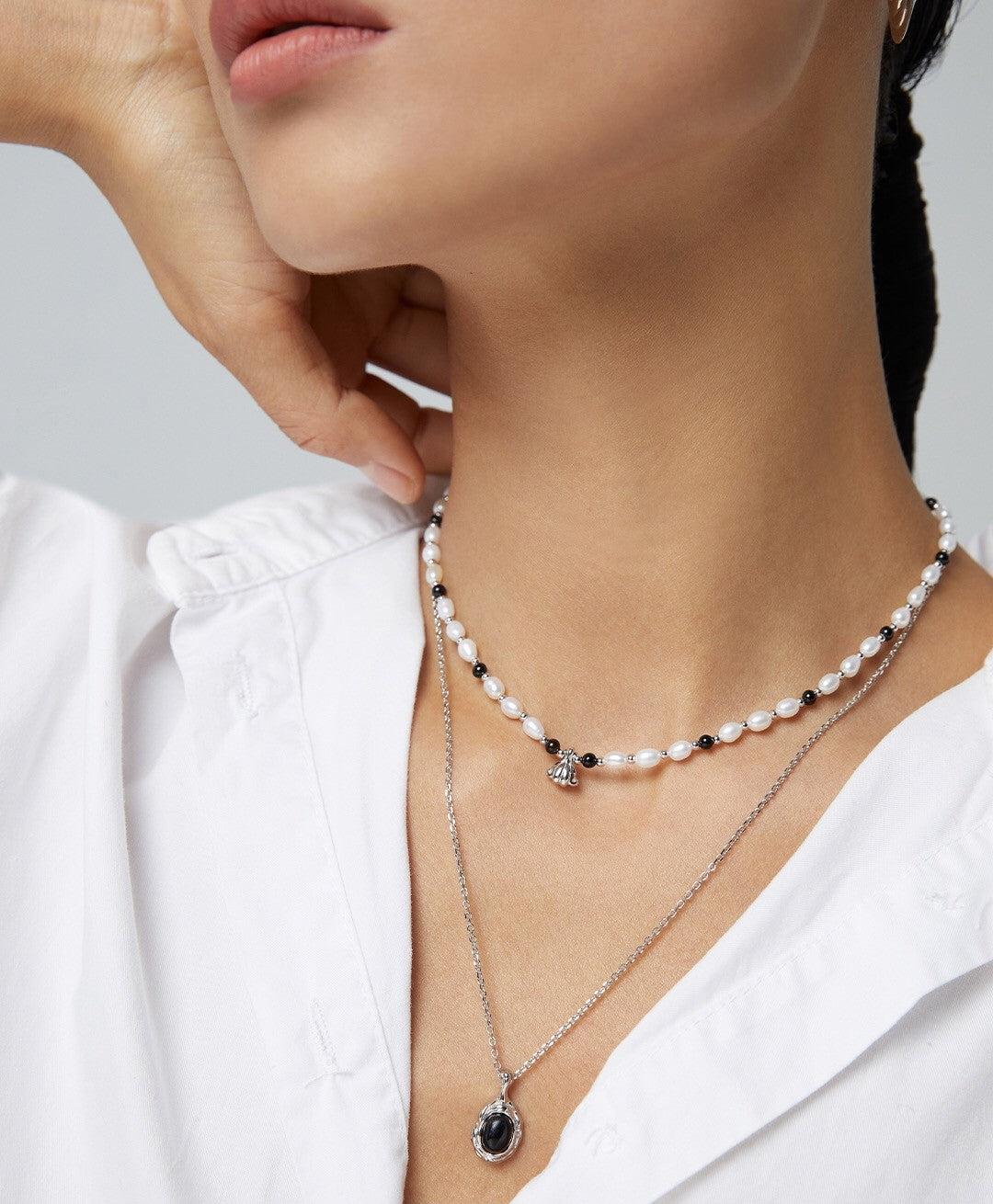 A stunning Spaced Black Onyx Pearl Pendant Necklace featuring natural pearls, black onyx, and gold vermeil accents, elegantly displayed.