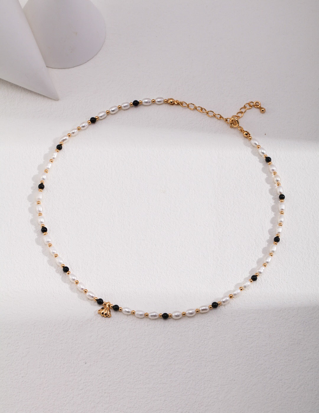 A stunning Spaced Black Onyx Pearl Pendant Necklace featuring natural pearls, black onyx, and gold vermeil accents, elegantly displayed.