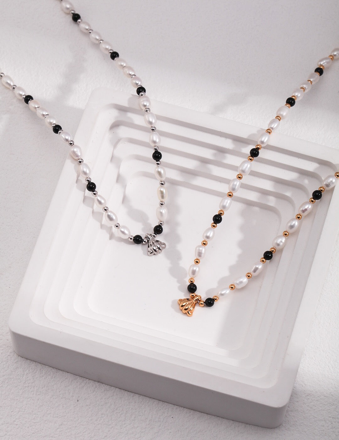 A stunning Spaced Black Onyx Pearl Pendant Necklace featuring natural pearls, black onyx, and gold vermeil accents, elegantly displayed.